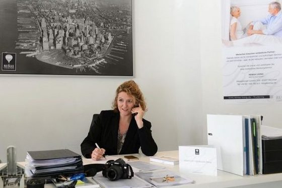 Eine Frau sitzt in einem Büro, telefoniert und macht sich Notizen. (Foto: Christof Stache)