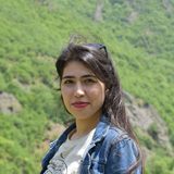 Fatemeh Raeika Vahedi in front of a hill