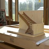 In einem sonnendurchfluteten Raum steht eine Modelltreppe aus Holz auf einem hölzernen Arbeitstisch. (Foto: Axel Jusseit)
