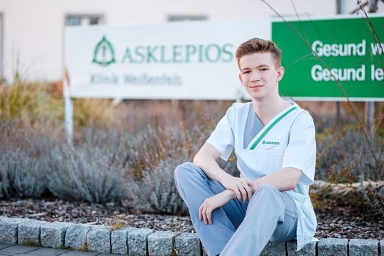 Leon vor Logo Asklepios Klinik Weißenfels.
